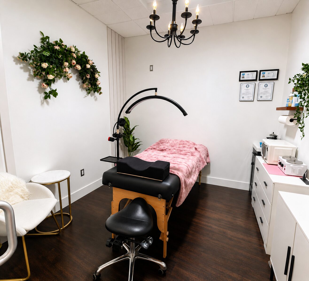 Interior of the Cindy Beauty lash studio with soft pink walls, ring light, white styling chair, and marble counter